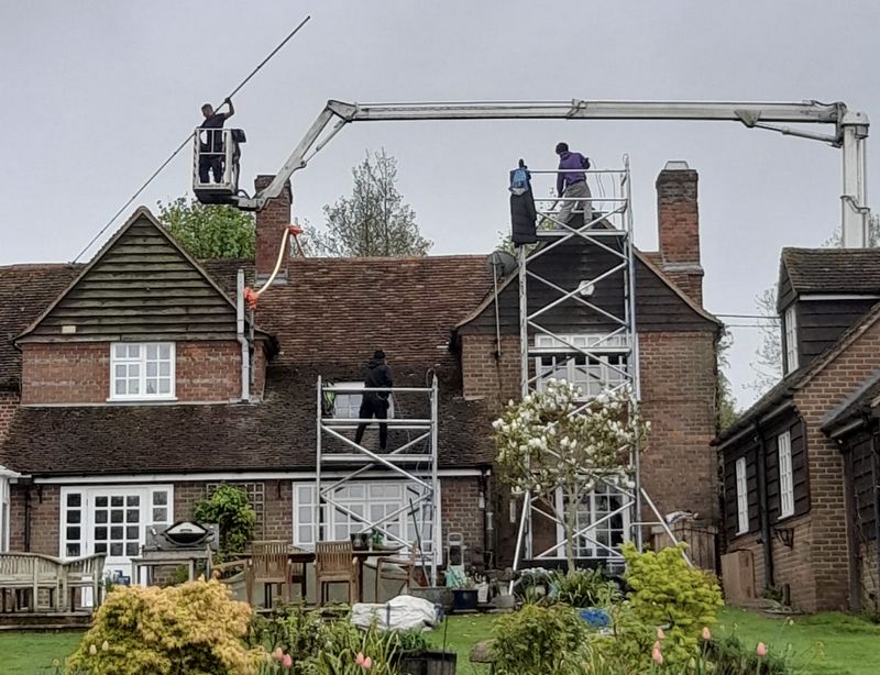 The Roof Moss Cleaners using cherry picker and scaffolding to clean roof safely and professionally in Royston, Hertfordshire