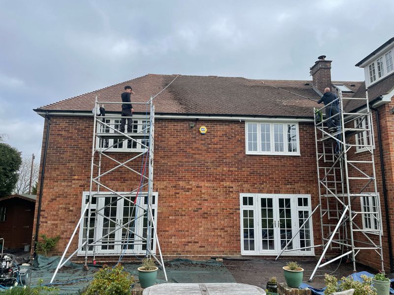 Roof cleaning carried out safely from scaffold towers by The Roof Moss Cleaners in Royston